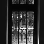 a black and white photo of a gated entrance to a building